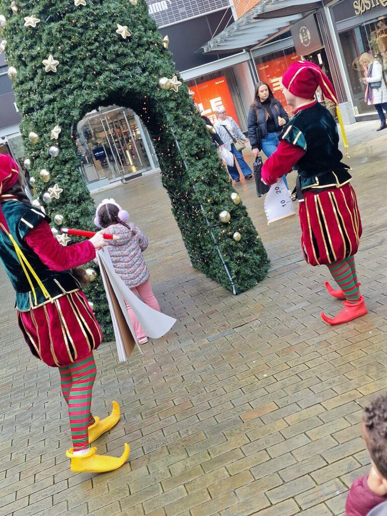 Elf & Safety - silly fun act where an Elf or Elves run around the local area and try and make sure everything is safe enough for Santa to swing by... gone are the days of parking your sleigh just anywhere, now it all needs to be Elf & Safety funny elf act Elf & Safety the Fun Christmas Performance