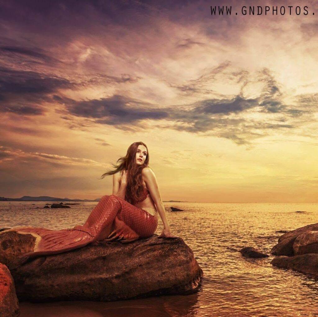 Mermaid on a rock Hire a mermaid hire event entertainment